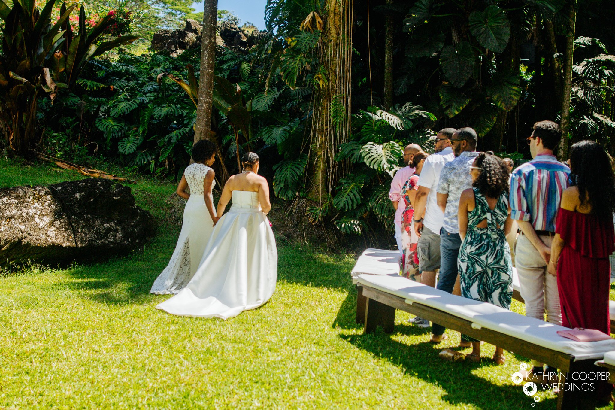 2 brides walk down the aisle together, then one at a time in LGBTQ wedding Hawaii